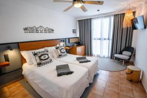 a hotel room with two beds and a chair at Coral Cotillo Beach in El Cotillo