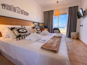 a hotel room with two beds and a large window at Coral Cotillo Beach in El Cotillo