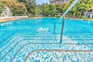 a swimming pool with blue tiles on the water at Coral Teide Mar in Puerto de la Cruz