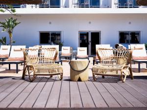 a group of chairs sitting on a wooden deck at Coral Cotillo Beach in El Cotillo