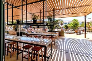 a restaurant with tables and chairs and a patio at Coral Cotillo Beach in El Cotillo