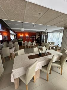 a dining room with a large table and chairs at restaurant motel dolorean in Săcele