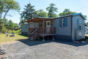a tiny house with a porch and a deck at Dragonfly Beach Retreat in Grayland