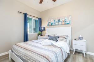 a bedroom with a bed with blue curtains and a window at Refreshing and Spotless 4 Bathrooms 22 in Ridgecrest