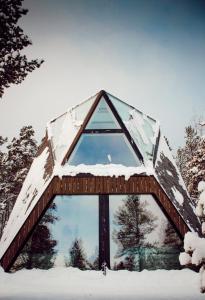 a building with snow on top of it at Trasti & Trine Boutique Hotel in Alta