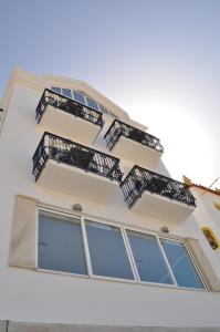 a building with balconies on the side of it at Hotel Mar Bravo in Nazaré