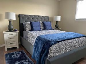 a bedroom with a bed with blue sheets and two lamps at Hammer Haus III in Waterloo