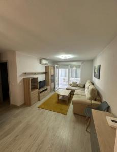 a living room with a couch and a table at Marina in Torrevieja