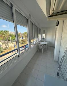 a room with windows and a table and chairs at Marina in Torrevieja