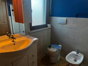 a bathroom with a sink and a toilet at Greenhouse Torino in Turin