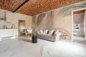 a living room with a couch and a table at Fanstastic 2BDRM Biella Center! in Biella