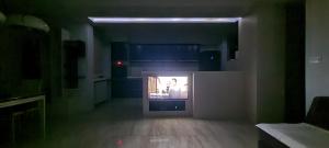 a dark living room with a tv in a room with at Heart of Skopje Luxury Apartment in Skopje
