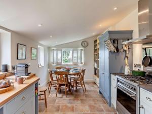 a kitchen with a table and a dining room at 3 Bed in Charmouth 93420 in Charmouth