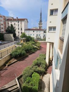 a view of a street in a city with a tower at Chambre - Vanves Porte de Versailles in Vanves