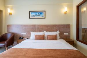 Rúm í herbergi á Hotel Haven O' Ganga
