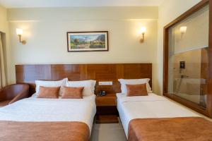 Rúm í herbergi á Hotel Haven O' Ganga