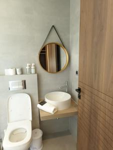 a bathroom with a sink and a toilet and a mirror at Villa Elia in Tamaris