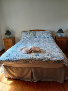 a bedroom with a bed with two towels on it at The Cobbler Rosscarbery Holiday Cottage in Rosscarbery