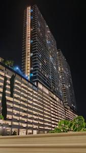 un grande edificio di notte con un edificio alto di The Best Luxury suites Asia Spacious 3BR Sea View a Jelutong