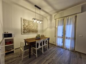 a dining room with a wooden table and chairs at Lago fuori in Clusane sul Lago