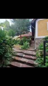 a set of stairs leading up to a house at Kertből a hegyre Nyaralóház Mindszentkálla in Mindszentkálla +20 photos