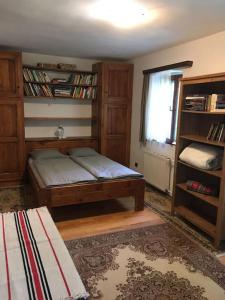 a bedroom with a bed and a book shelf at Kertből a hegyre Nyaralóház Mindszentkálla in Mindszentkálla