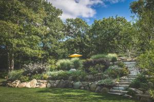 a garden with stairs and an orange umbrella at PREMIUM PROPERTY - Private 2-Acre Retreat - MODERN 4 Bedrooms - See Video Tour in Gloucester