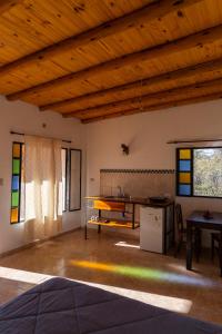 a room with a table and some stained glass windows at Hospedaje Sauce Linda - Casa Brea in Piedra Pintada