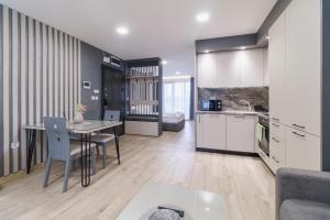 a kitchen and living room with a table and chairs at LDV 13 Residence Free private parking in Plovdiv