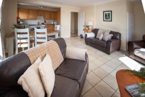 a living room with a couch and a kitchen at Waterfront View Apartment in Carrick on Shannon