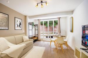 a living room with a couch and a table at La Vie en Rose in Barentin