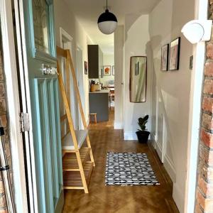 a hallway of a home with stairs and a rug at Flat1Hove- renovated, 2BR, patio, beach, free onsite parking in Hove