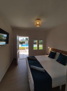 a bedroom with a large bed and a view of a pool at Remanso de Paz cerca de Sevilla DreamerTu in Palomares del Río