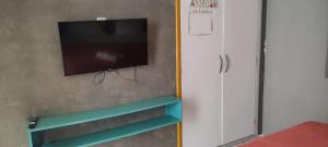 a flat screen tv hanging on a wall at Hostel e Pousada Boa Vista in Recife