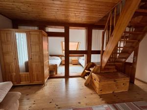 a room with a wooden staircase in a house at Ferienhof Schmetterlingsgarten in Jakobshagen