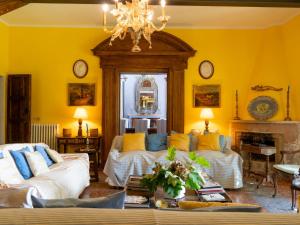 ein Wohnzimmer mit zwei Sofas und einem Kronleuchter in der Unterkunft Villa Il Giardino Di Eugenia by Interhome in Viceno