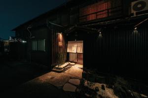an entrance to a building at night at KIKUNOYA-gashu- 一棟貸切宿-日式私人旅馆 in Nagoya +22 photos