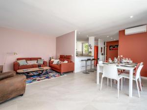 a living room with a couch and a table at Holiday Home Domaine de Maure Vieil by Interhome in La Napoule-Plage