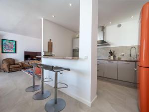 a kitchen with two stools and a counter in a room at Holiday Home Domaine de Maure Vieil by Interhome in La Napoule-Plage