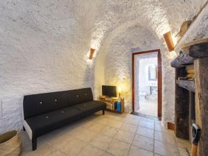 a living room with a couch and a fireplace at Holiday Home Casa Cueva Maria Zambrano by Interhome in Terque