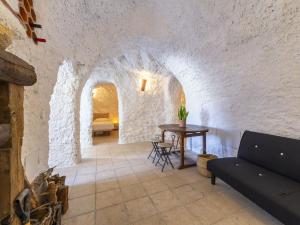 a living room with a couch and a table at Holiday Home Casa Cueva Maria Zambrano by Interhome in Terque +20 photos
