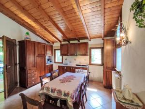 a kitchen with a table and chairs and a dining room at Holiday Home Relax by Interhome in Monti di Grandola