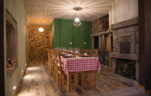 uma sala de jantar com uma mesa e uma parede verde em Casas do Terreiro em Seia