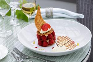 a white plate with a dessert on a table at Star Castle Hotel in Hugh Town