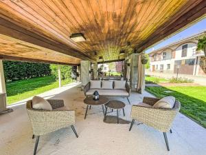 a patio with a couch and chairs and a table at Apartment Tenuta Beatrice by Interhome in CastellʼAlfero