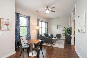 a living room with a table and chairs at Music Row w Free Parking in Nashville