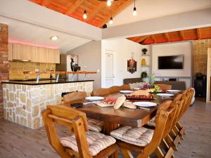 a dining room and kitchen with a table and chairs at Holiday Home Maja by Interhome in Donji Proložac