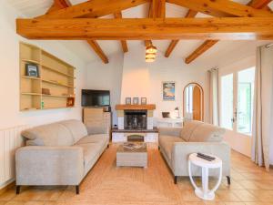 a living room with two couches and a fireplace at Holiday Home Casa Nostress-Villa 6 pers by Interhome in Noirmoutier-en-l'lle