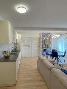 a kitchen and living room with a couch and a table at Apartamenty Olszynka in Górki Wielkie