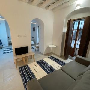 a living room with a couch and a table at Casa Florinda Tarifa in Tarifa